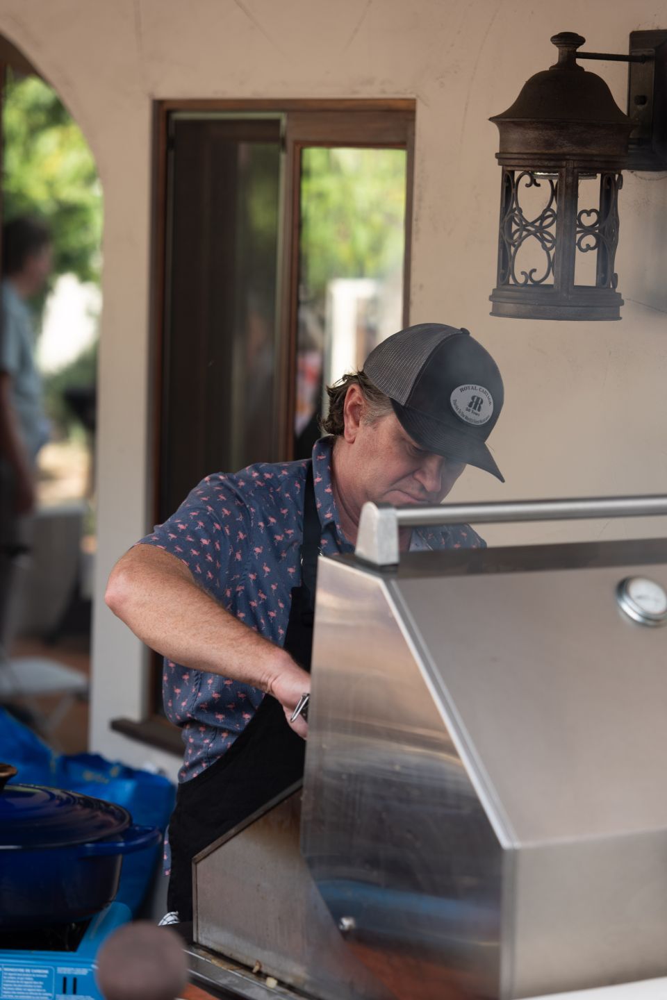 a man in a black ballcap at a bbq